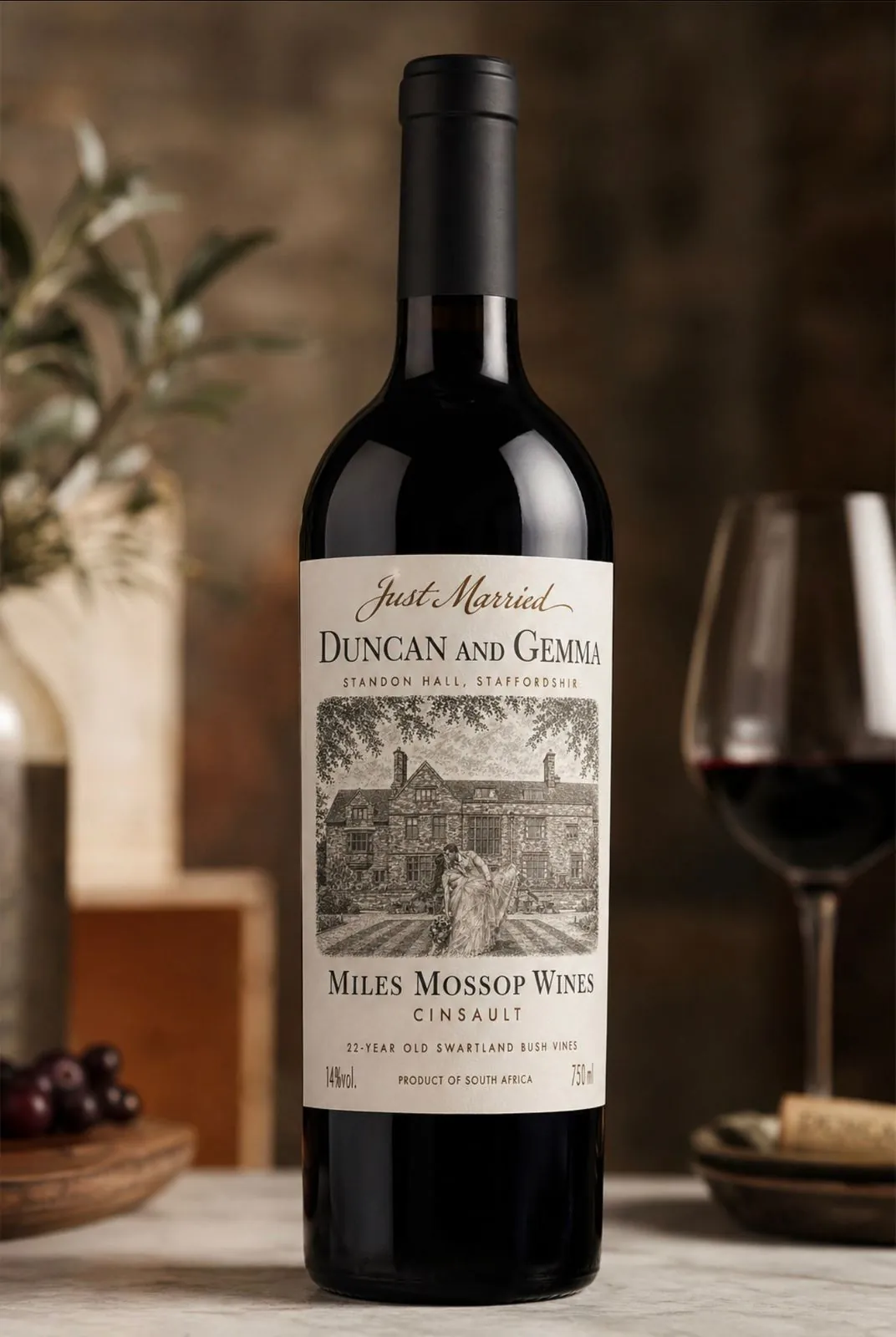 A bespoke-labelled bottle of South African red wine on a candle-lit table setting
